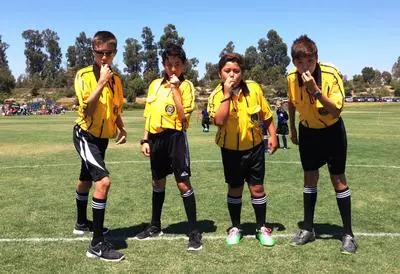 Youth soccer referees on the field