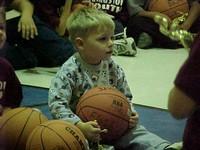 Toddler sitting with a basketball