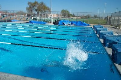 Swimmer splashing into the water